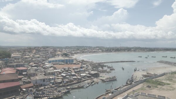 Elmina Castle Port Boats Fishing Shoreline Community Clouds Skies