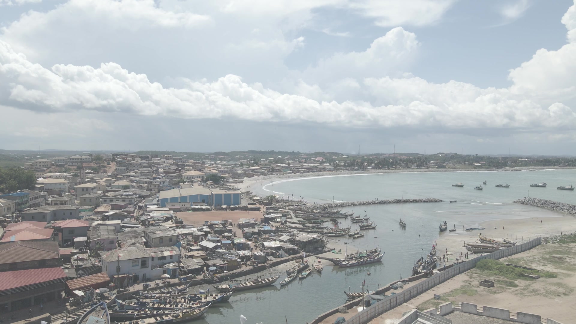 Elmina Castle Port Boats Fishing Shoreline Community Clouds Skies