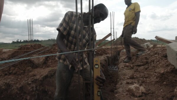 Construction Mason Checks Alignment Foundation