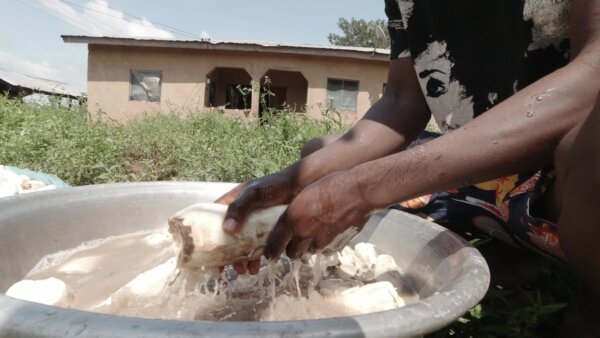 Man Washing Cassava In Water Pan Cleaning