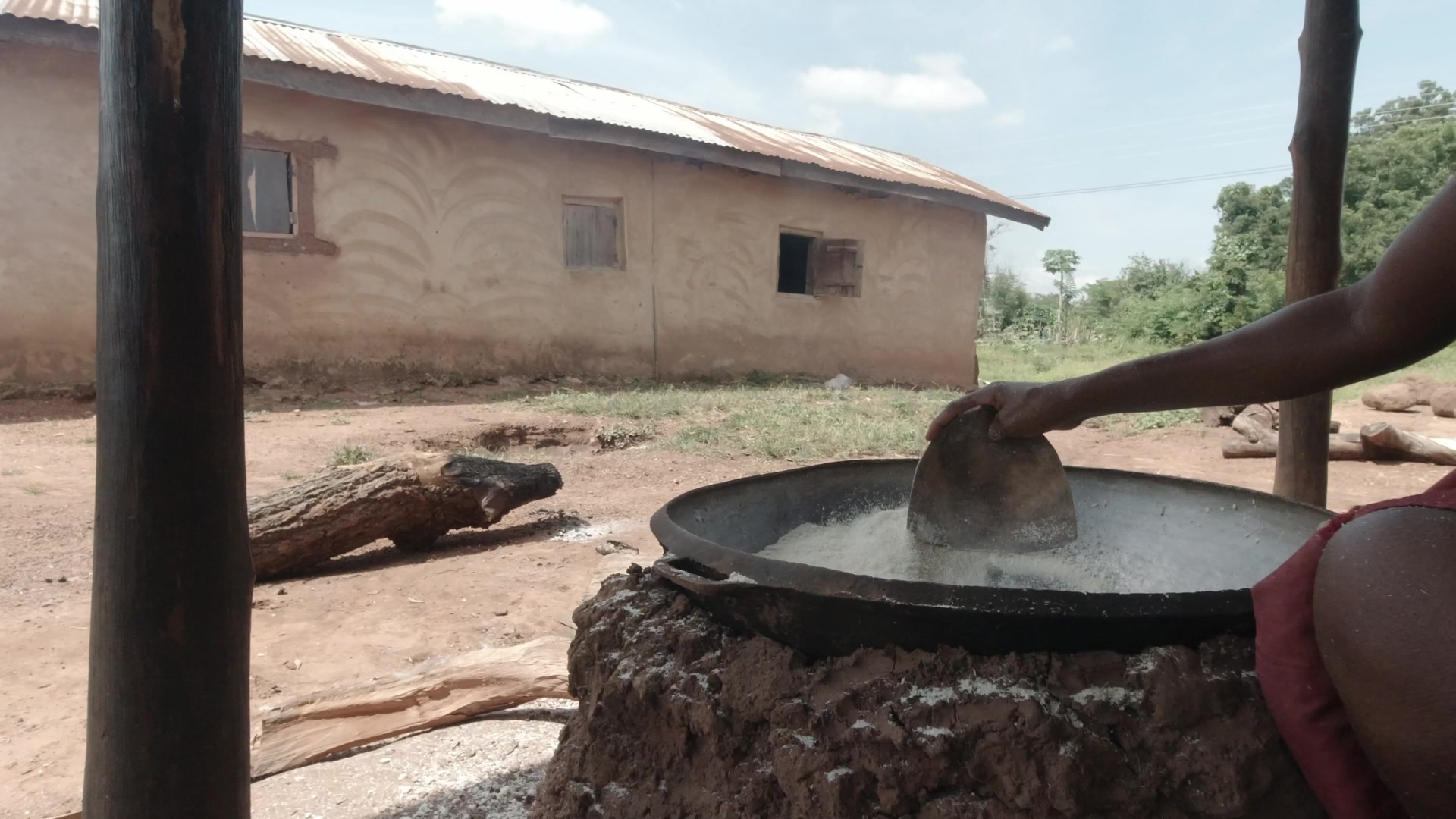 Woman Stir Gari In Pan On Fire