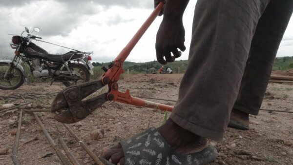 Worker Cut Iron Rods