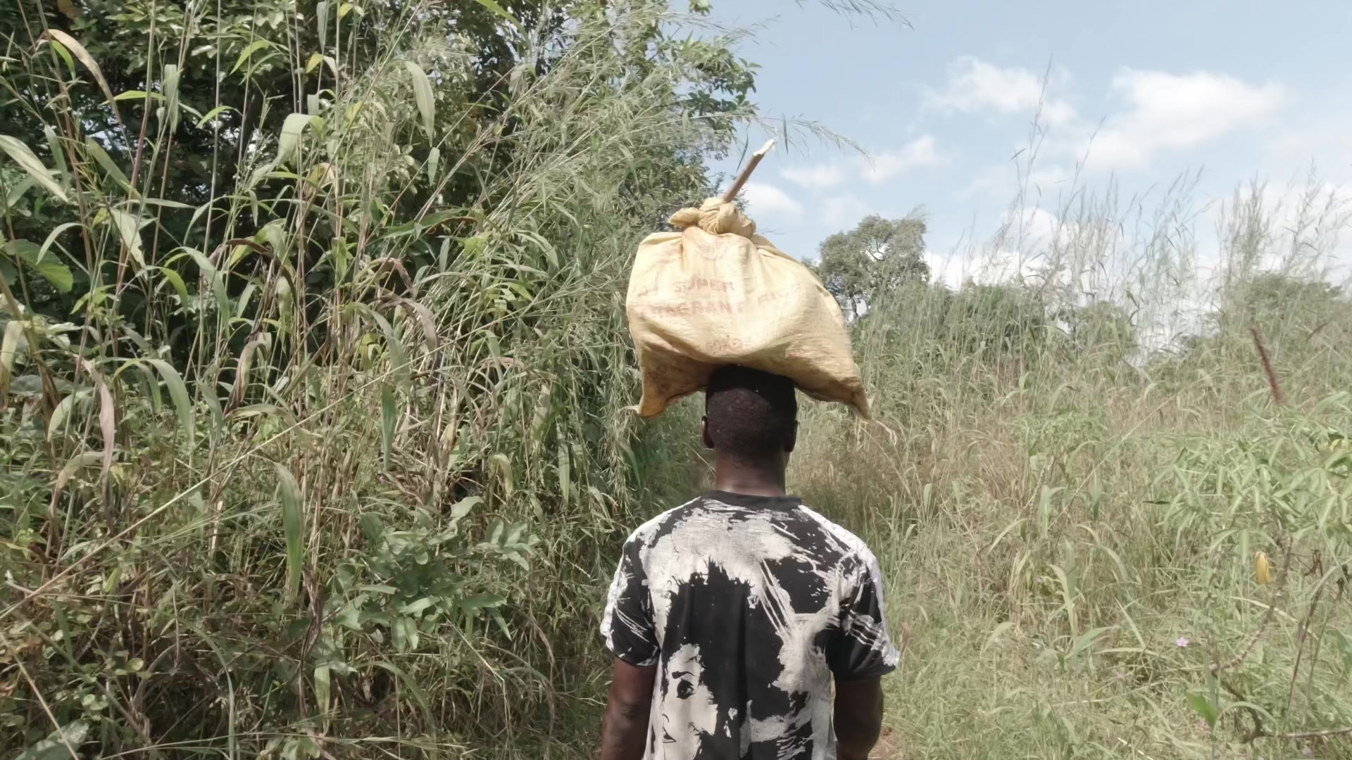 Young Boy Carrying Farm Produce